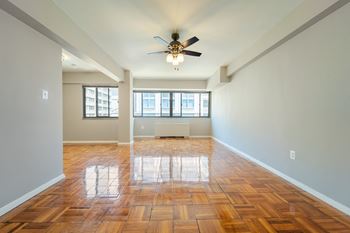 A room with wooden floors and a ceiling fan.